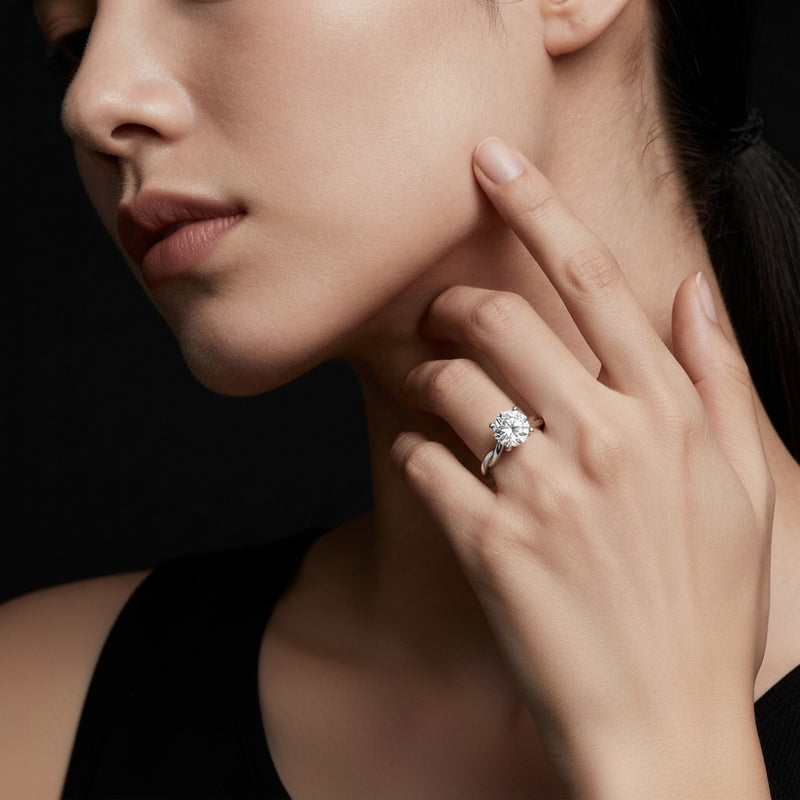 Model wearing round twisted shank solitaire engagement ring