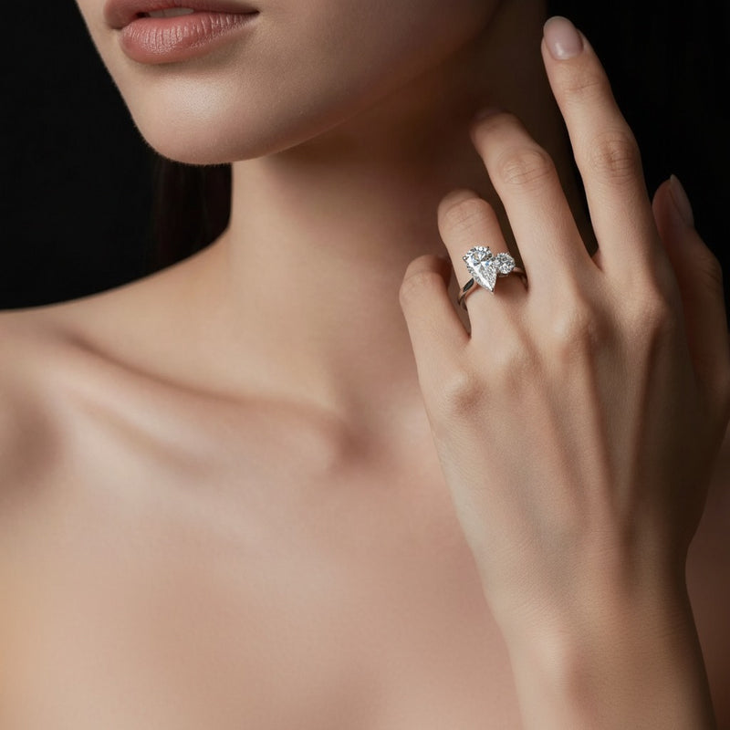 Model wearing pear toi et moi engagement ring