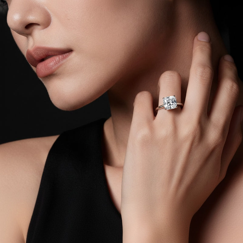 Model wearing round classic solitaire engagement ring
