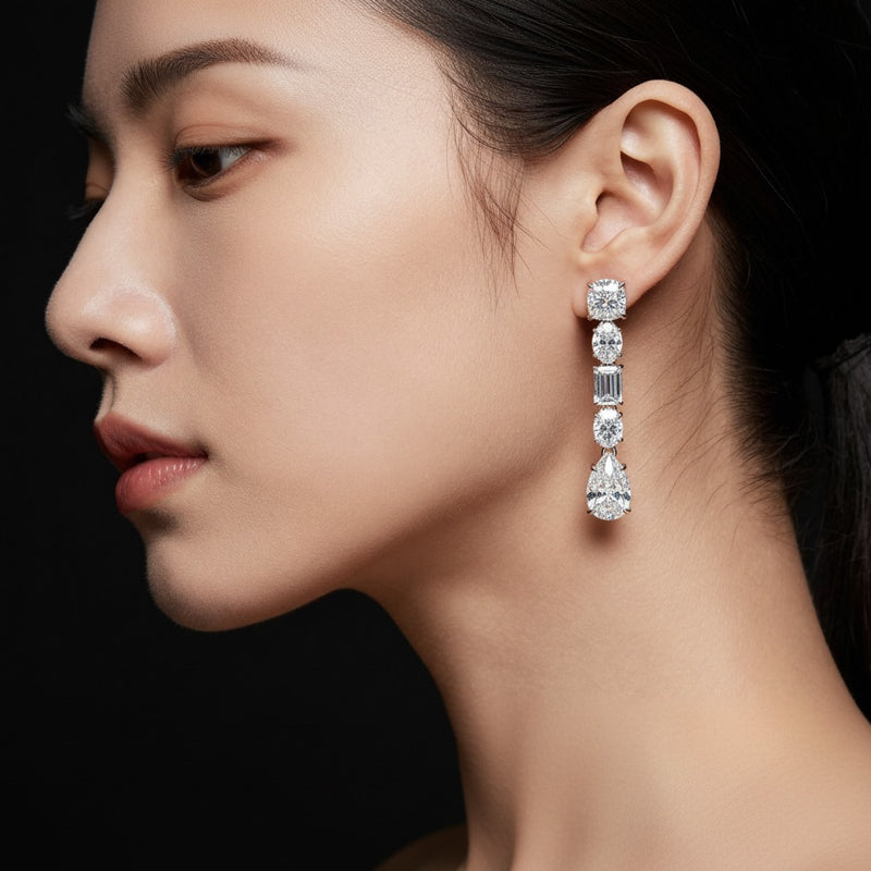 Model wearing pear dangle earrings