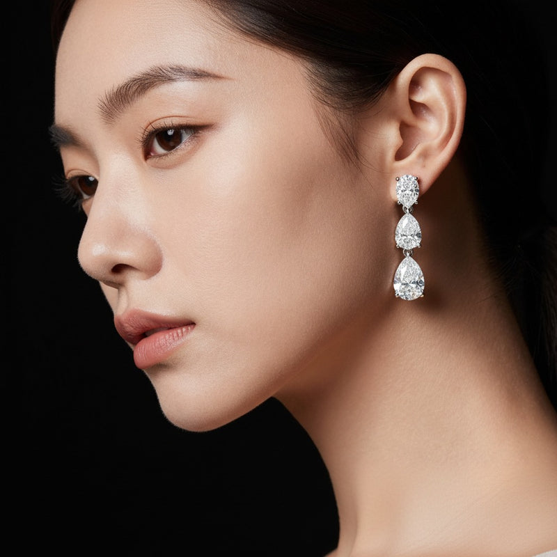 Model wearing pear dangle earrings
