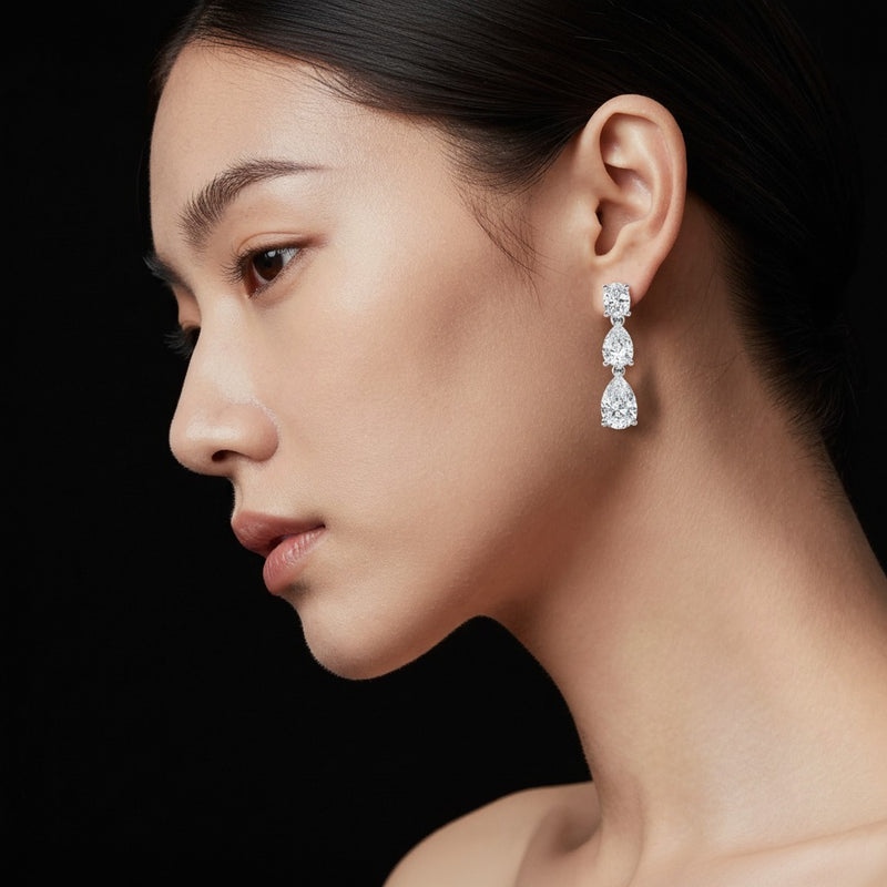 Model wearing pear lab grown diamond f vvs dangle earrings