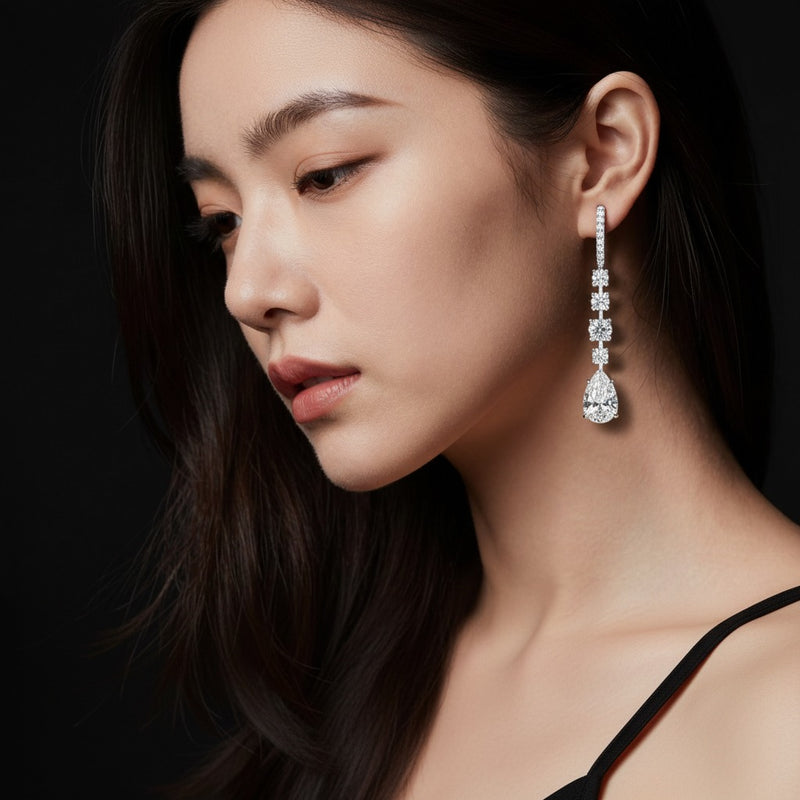 Model wearing pear dangle earrings