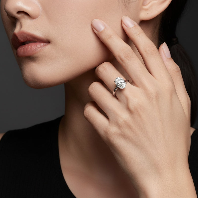 Model wearing oval east west solitaire ring