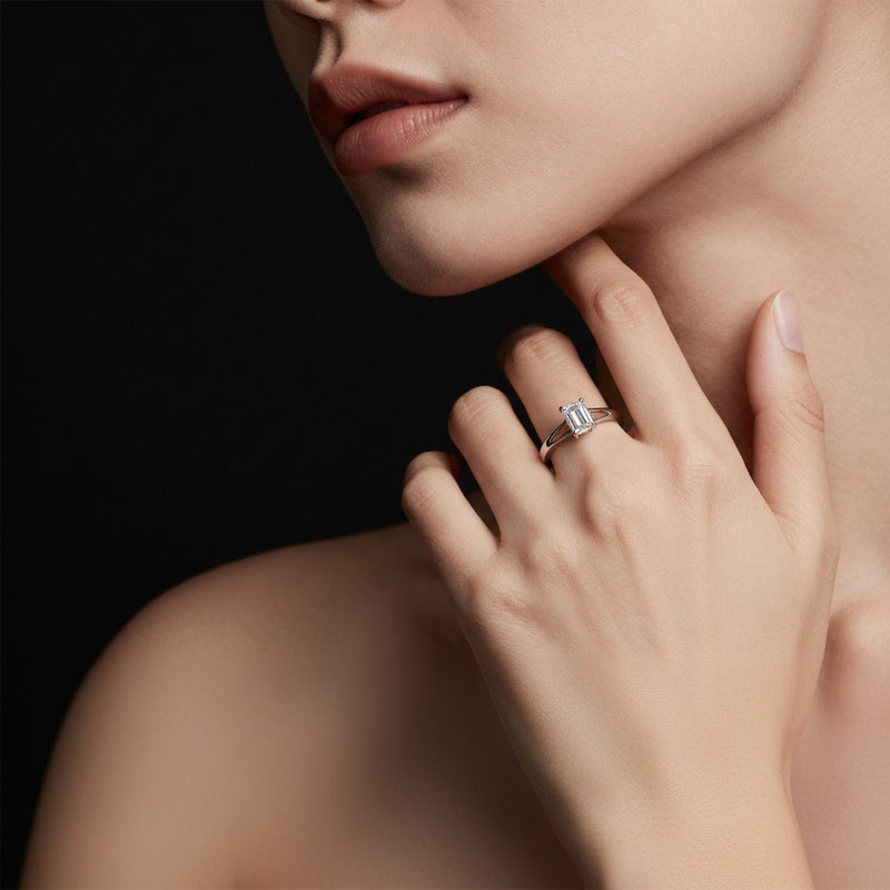 Model wearing emerald east west solitaire ring