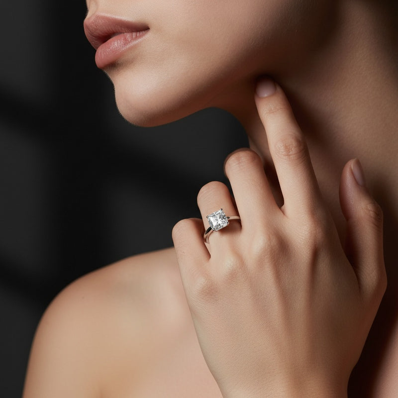 Model wearing cushion east west solitaire ring