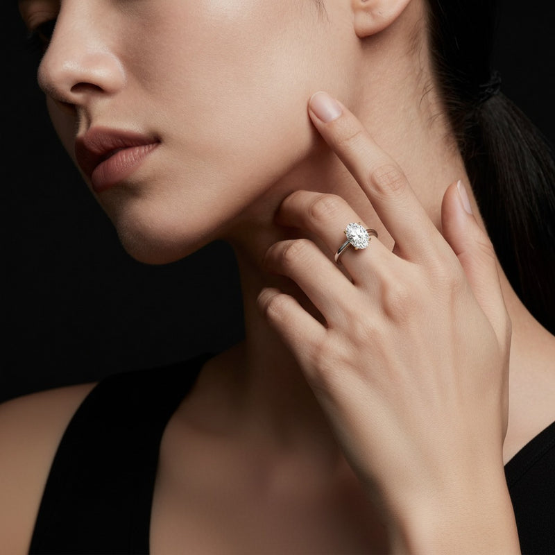 Model wearing oval solitaire engagement ring