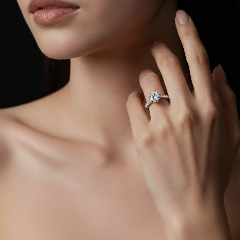 Model wearing round solitaire engagement ring