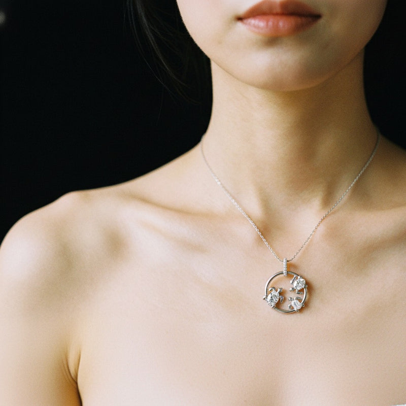 Model wearing oval baby turtle pendant