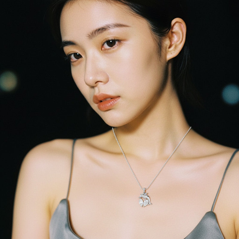 Model wearing marquise dolphin pendant