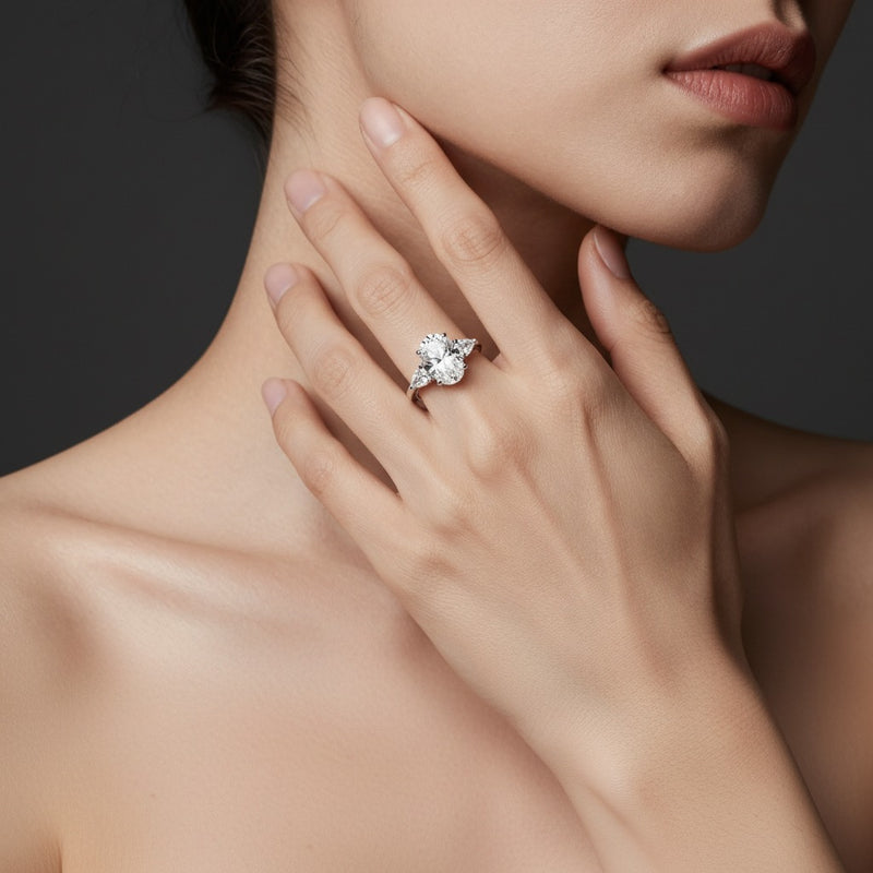 Model wearing oval accented three stone ring