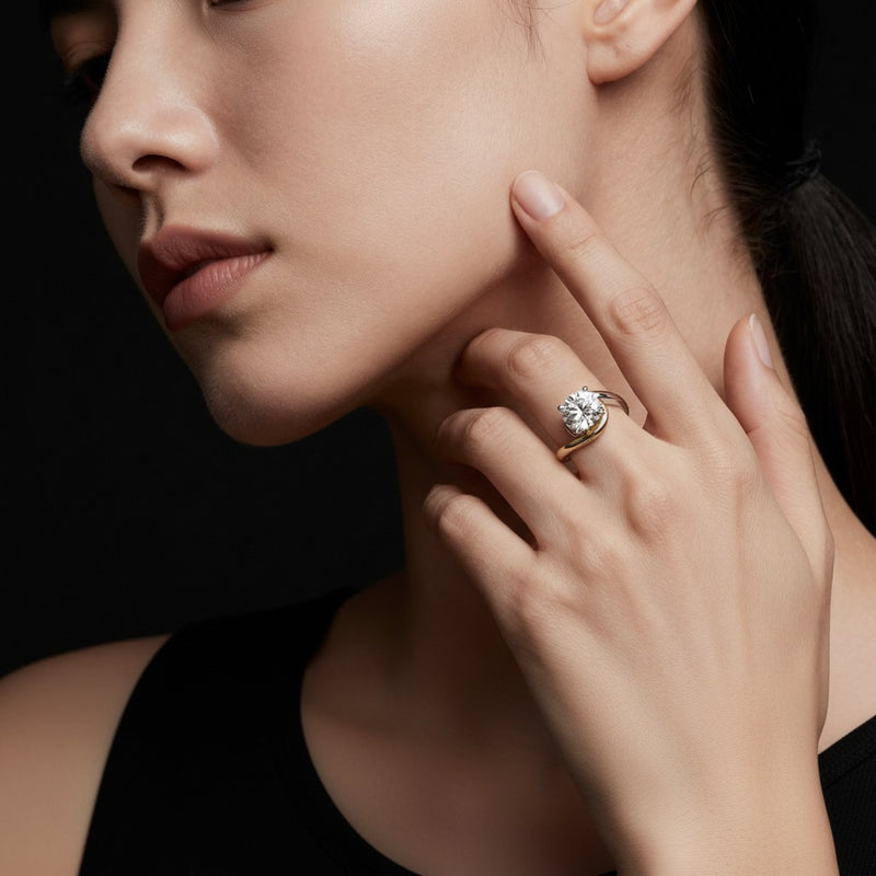 Model wearing round solitaire engagement ring
