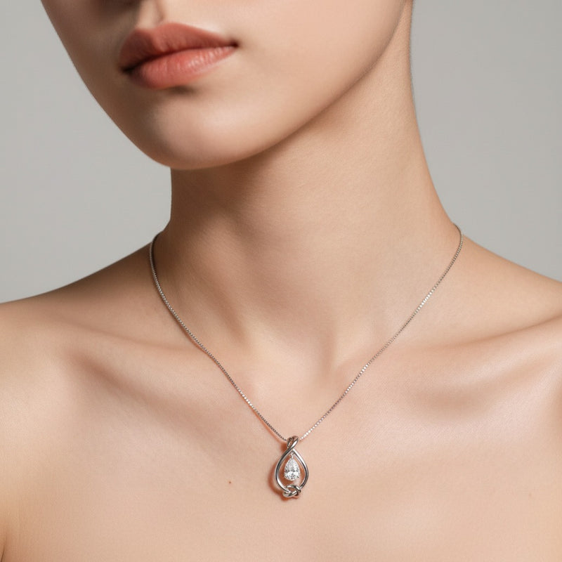 Model wearing pear solitaire knot pendant