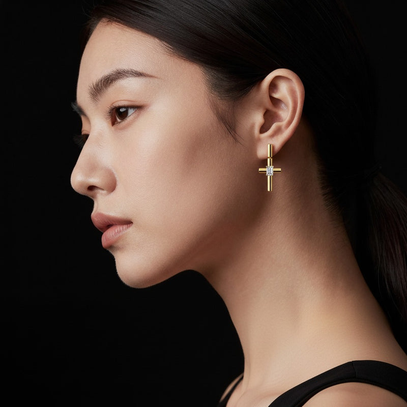 Model wearing emerald cross earrings