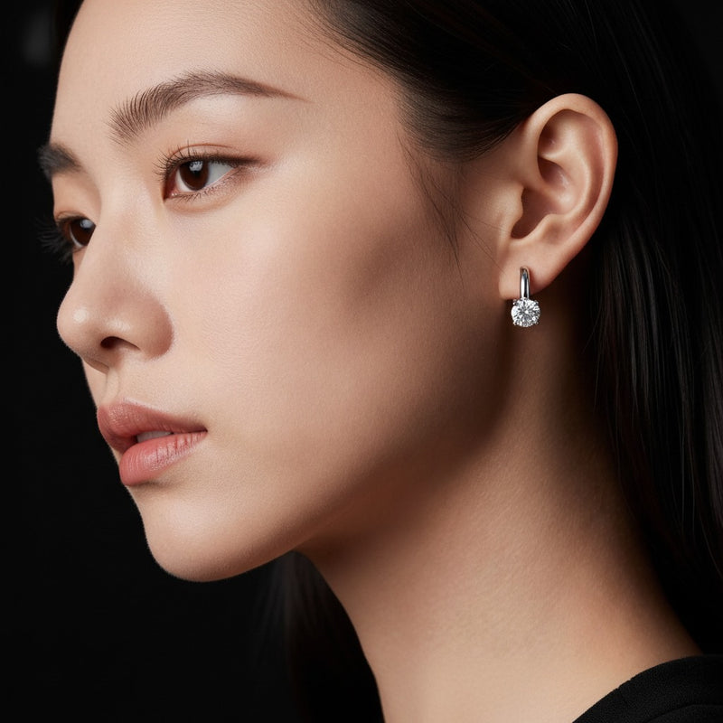 Model wearing round huggie cuff earrings