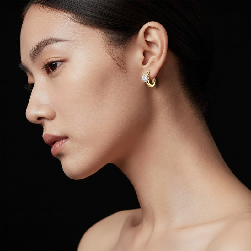 Model wearing round huggie cuff earrings