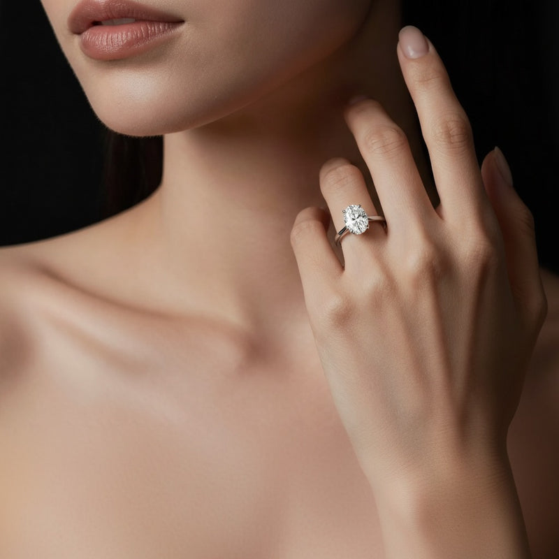 Model wearing oval bold split shank solitaire engagement ring