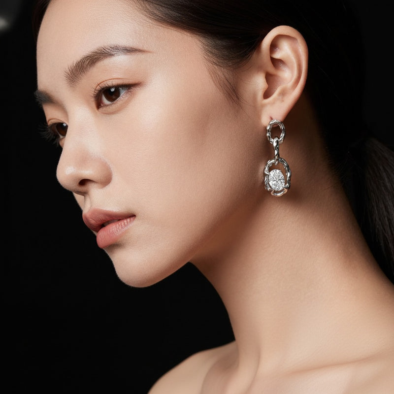 Model wearing oval earrings