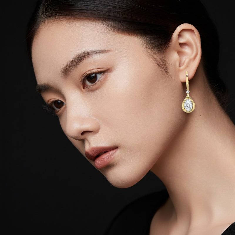 Model wearing pear dangle earrings
