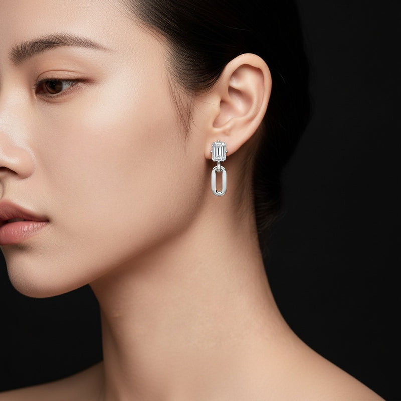 Model wearing emerald paperclip dangle earrings
