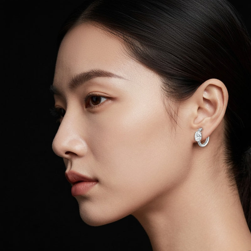 Model wearing oval hoop earrings
