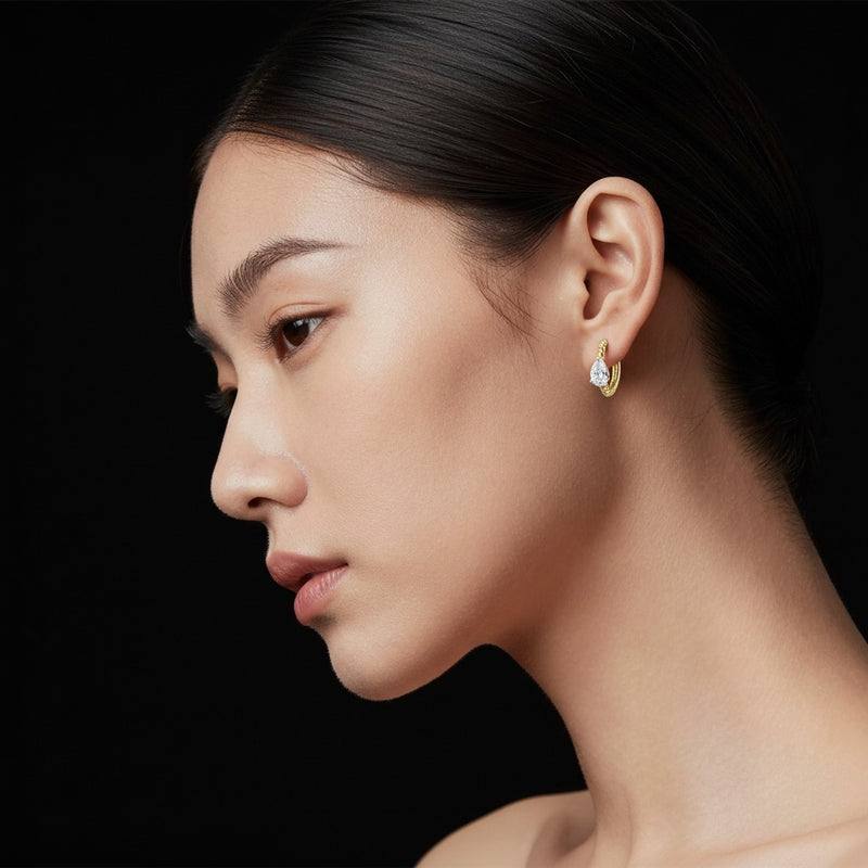 Model wearing pear hoop earrings