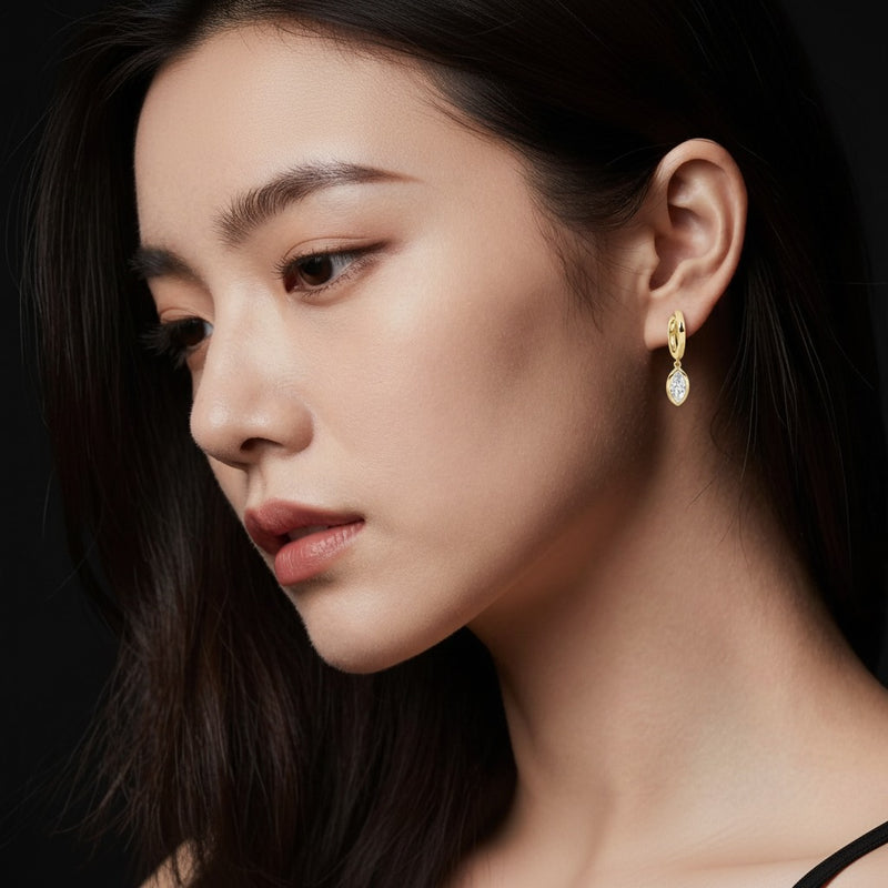 Model wearing marquise dangle earrings