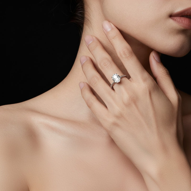 Model wearing oval petite solitaire engagement ring