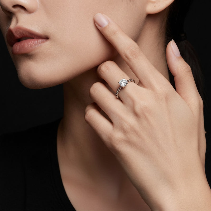 Model wearing round petite solitaire engagement ring