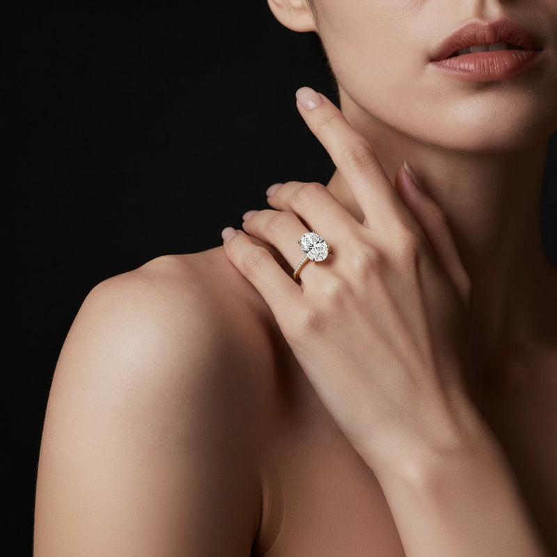 Model wearing oval accented solitaire engagement ring