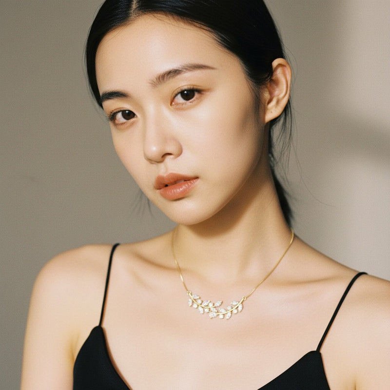 Model wearing pear leaf motif fashion necklace