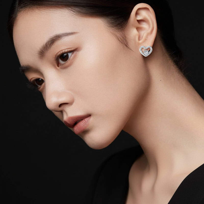 Model wearing round heart earrings