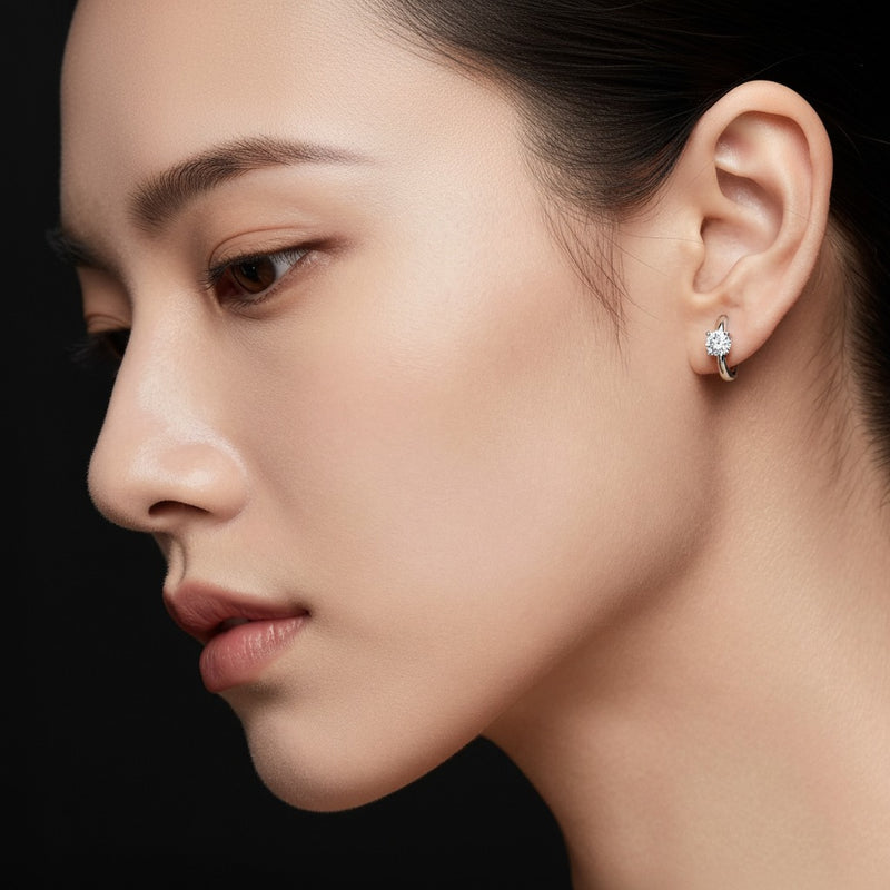 Model wearing round huggie earrings