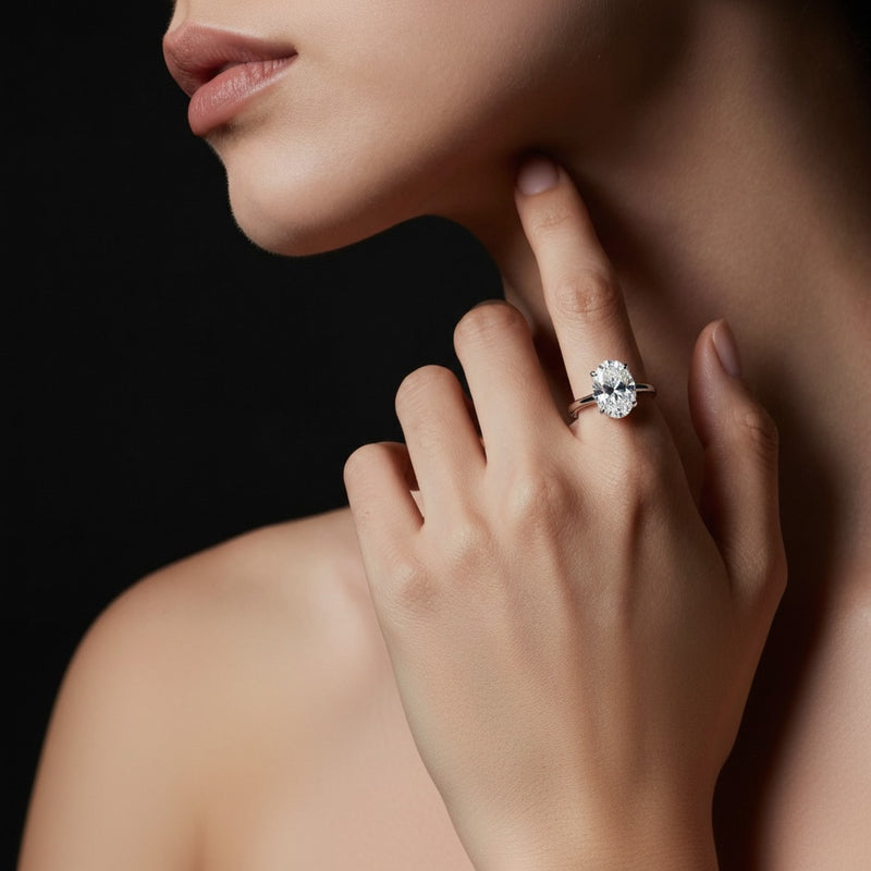 Model wearing oval lab grown diamond classic solitaire ring