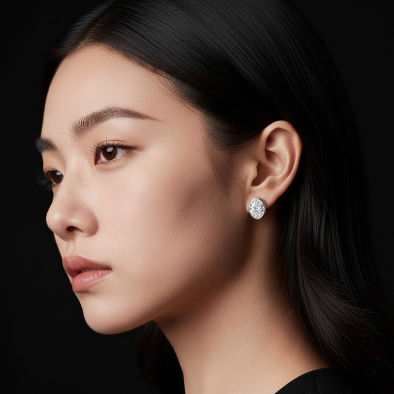Model wearing oval bezel set stud earrings