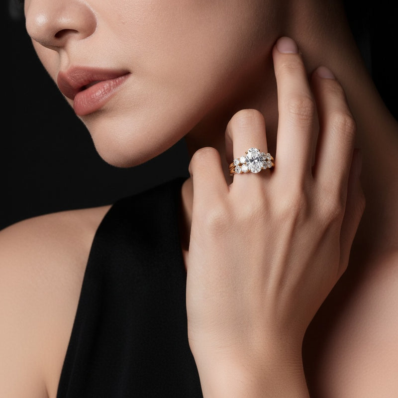Model wearing oval bridal set with matching band and ring