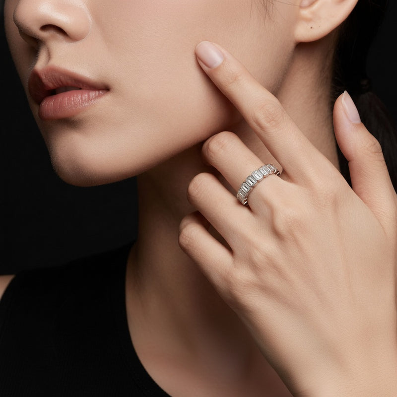 Model wearing emerald eternity band ring