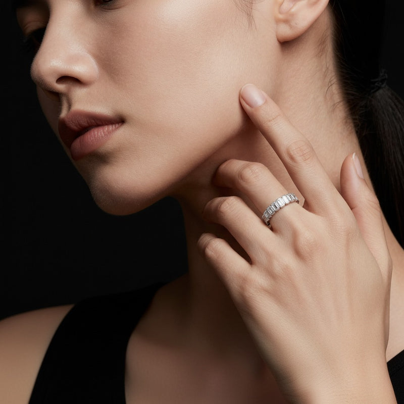 Model wearing emerald eternity band ring