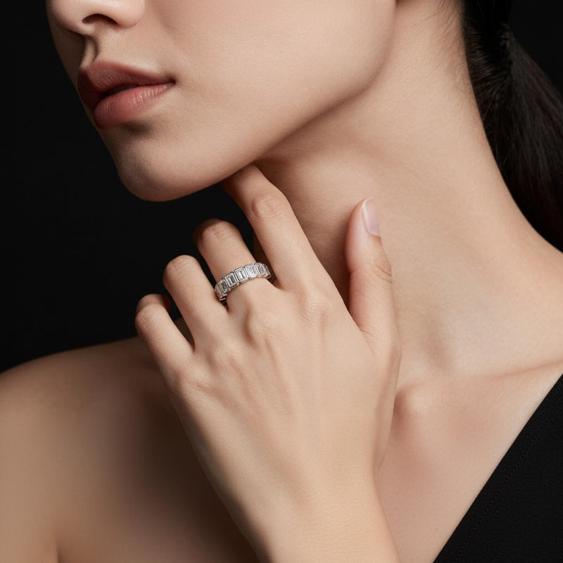 Model wearing emerald eternity band ring