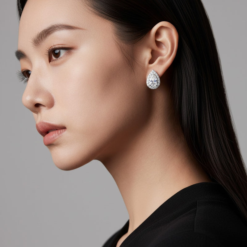 Model wearing pear lab grown diamond f vvs halo stud earrings