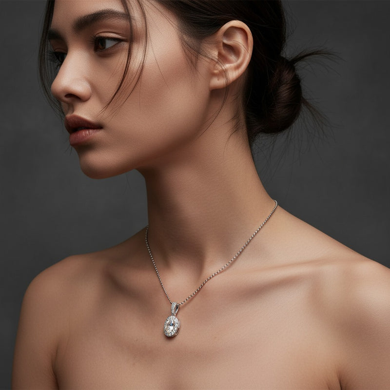 Model wearing oval halo pendant