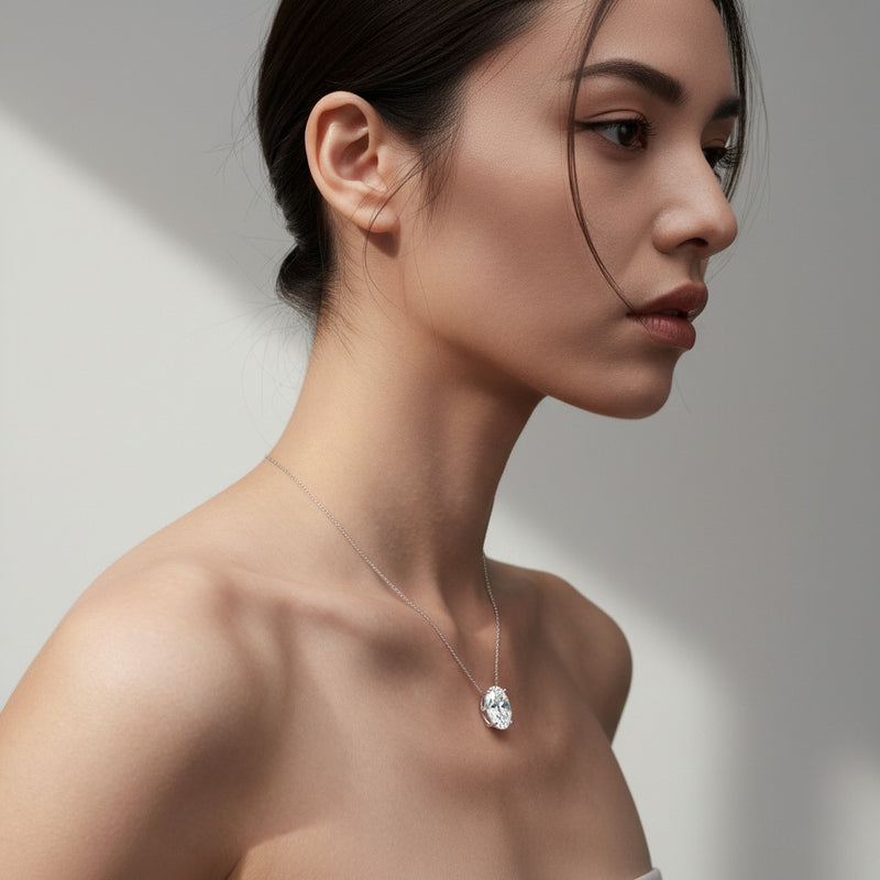 Model wearing oval east west solitaire necklace