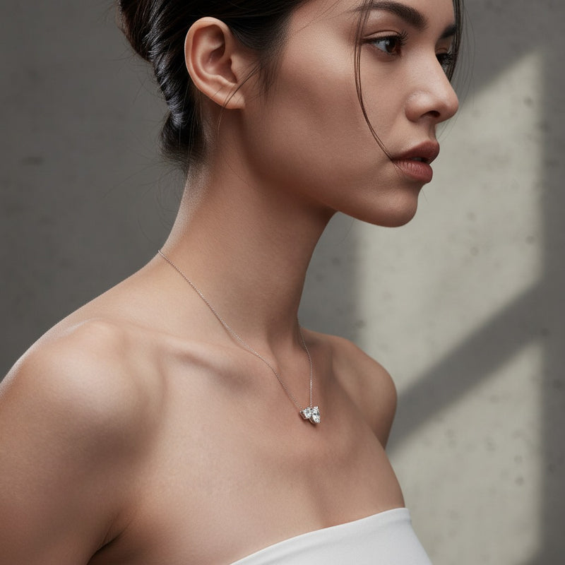Model wearing pear east west solitaire necklace