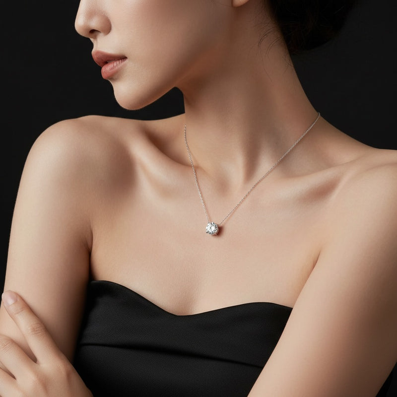 Model wearing round solitaire necklace