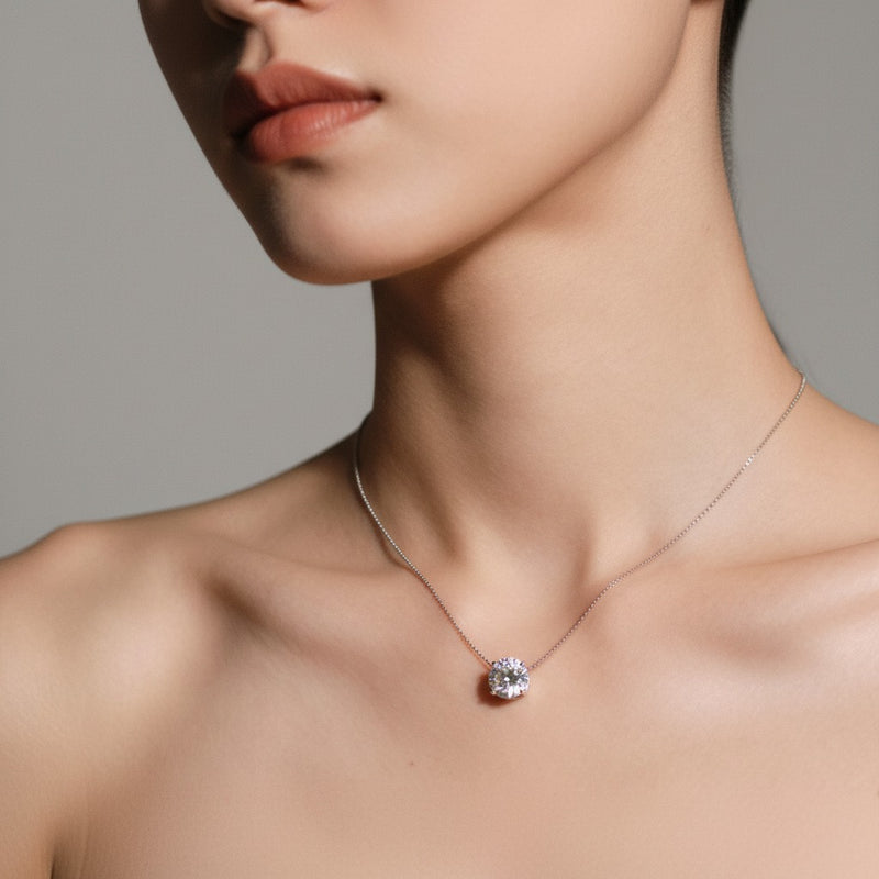 Model wearing round solitaire necklace