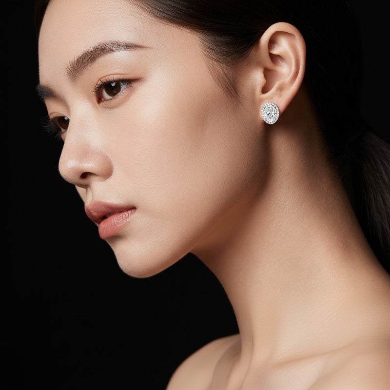 Model wearing oval halo stud earrings