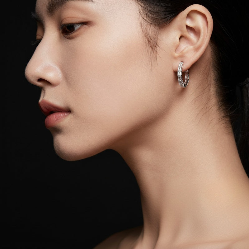 Model wearing emerald inside out hoop earrings