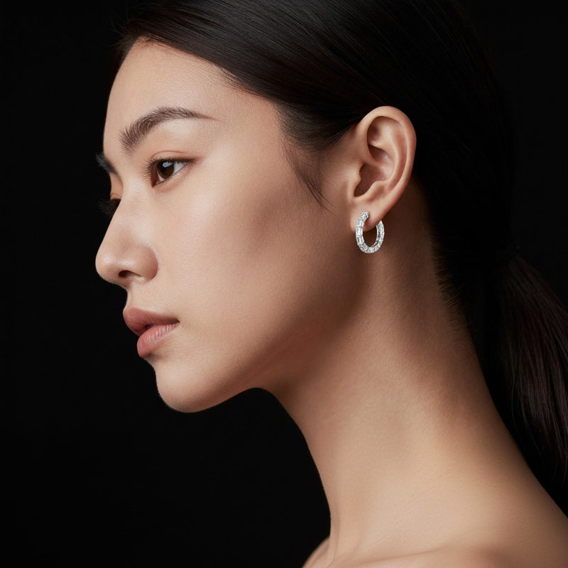 Model wearing oval inside out hoop earrings