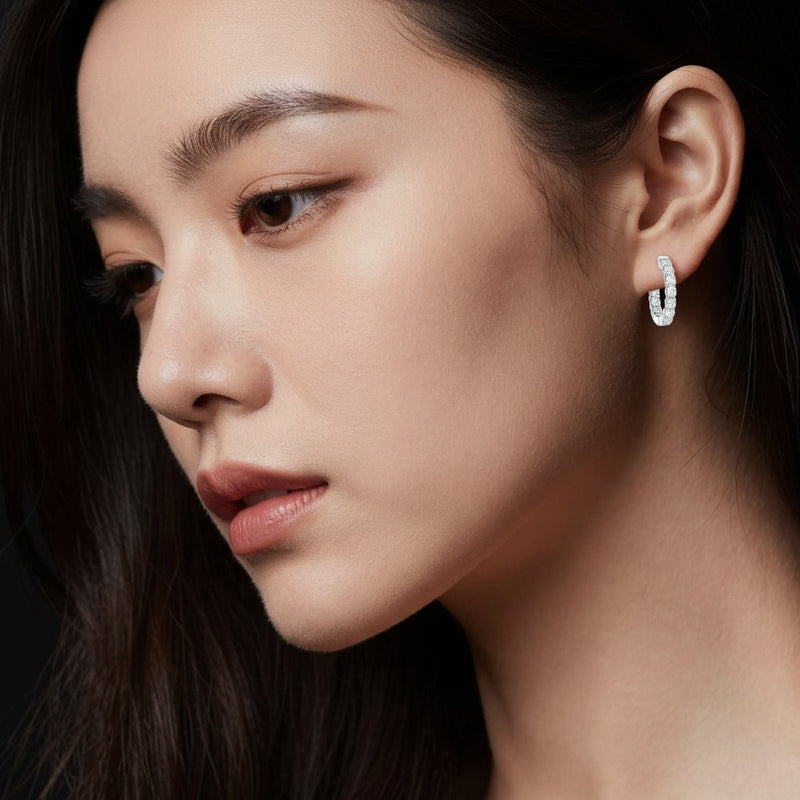 Model wearing round inside out hoop earrings