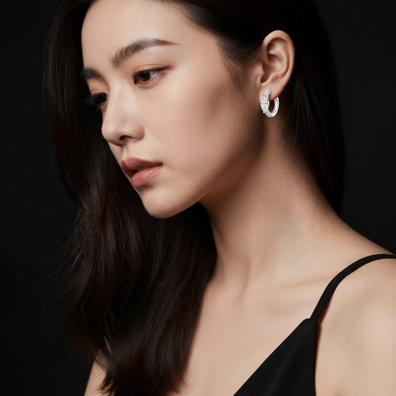 Model wearing marquise solitare accent huggie earrings
